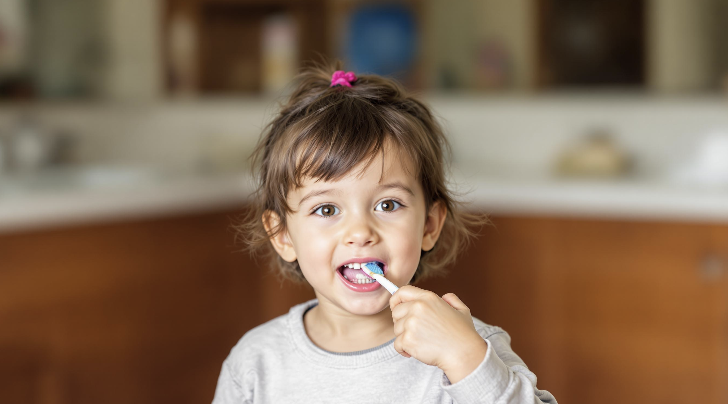Child brushing teeth demonstrating proper hygiene