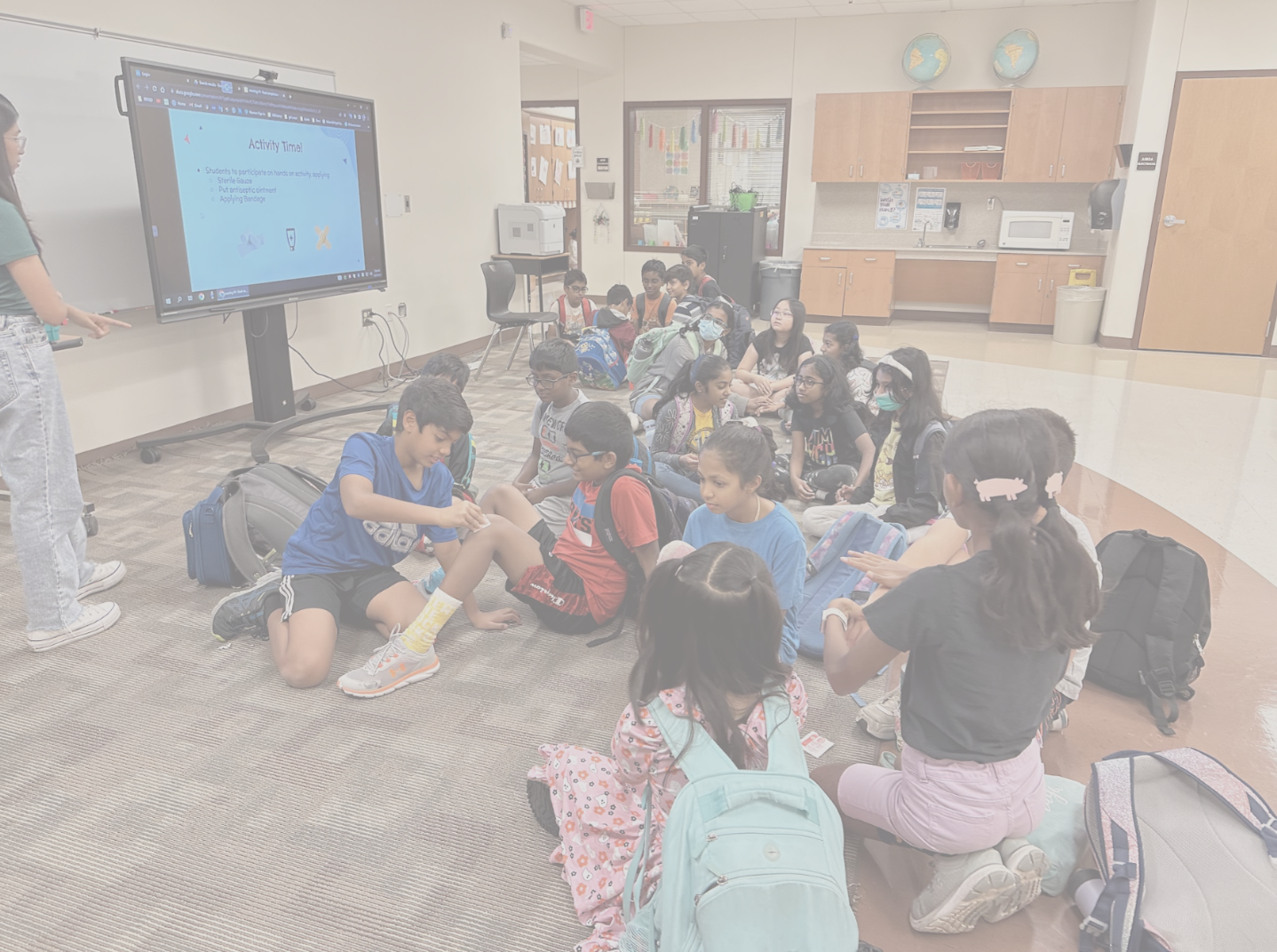 Children learning life-saving skills in a classroom